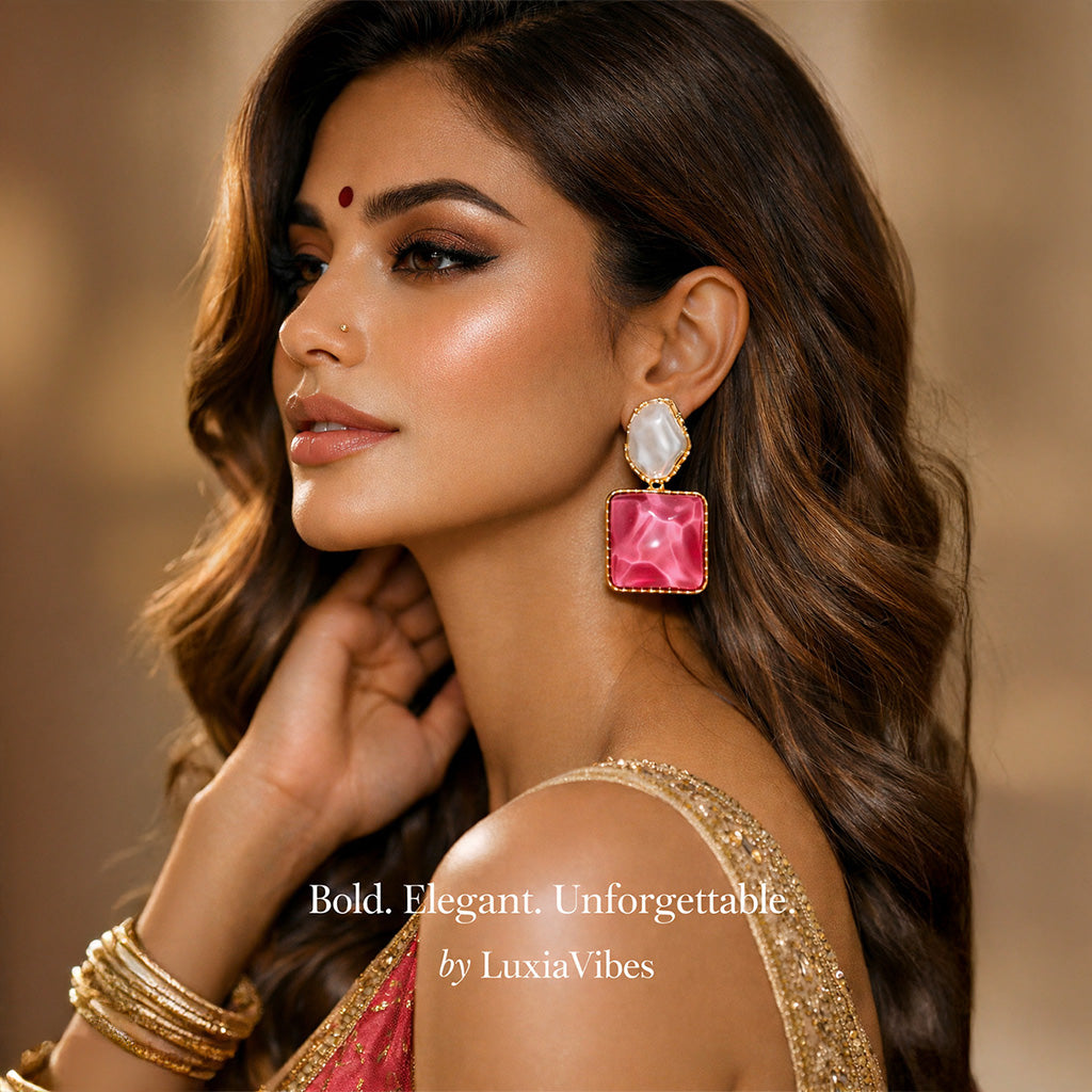 Woman wearing pink earrings with a blurred background, featuring LuxiaVibes branding.