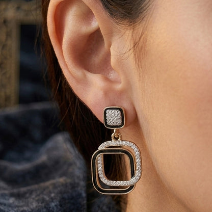 White crystal square drop earrings sparkling on black background
