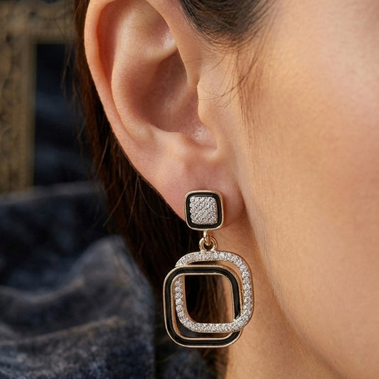 White crystal square drop earrings sparkling on black background