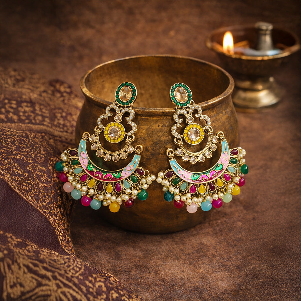 Closeup of multicolor chandbali earrings with enamel work and pearl bead detailing