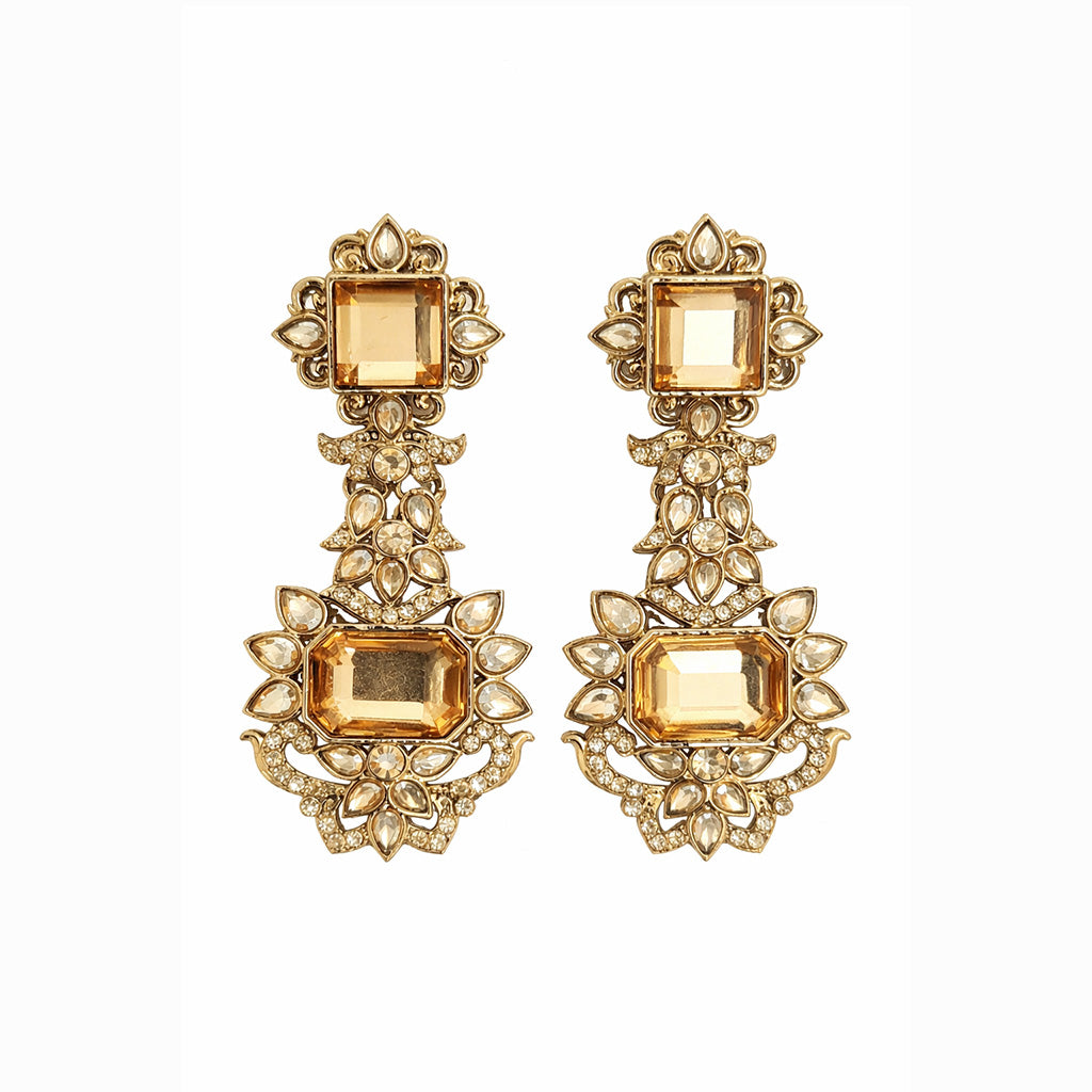 Gold statement chandelier earrings with champagne stones on white background