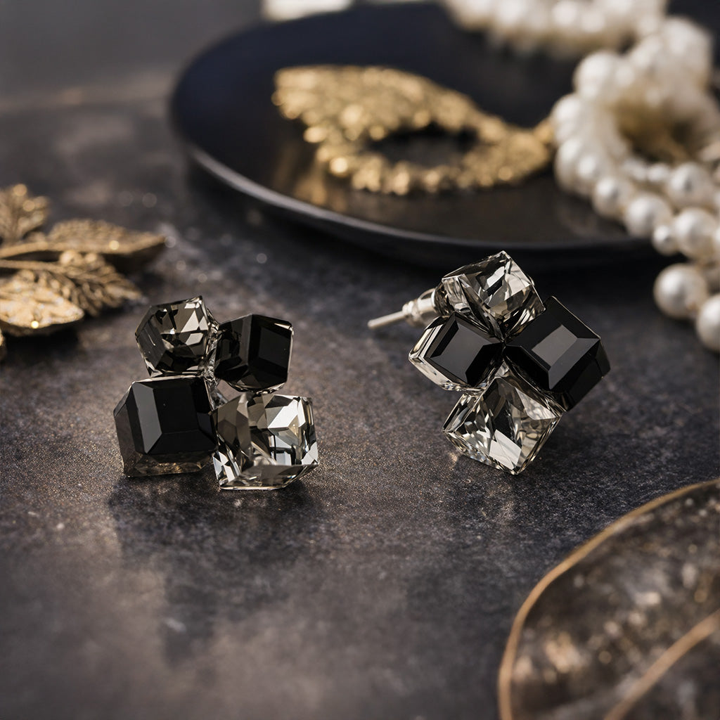 Faceted crystal stud earrings sparkling on black background