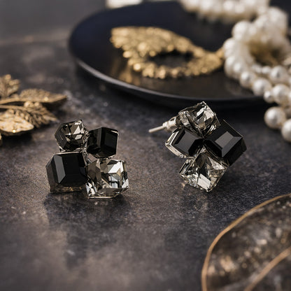 Faceted crystal stud earrings sparkling on black background