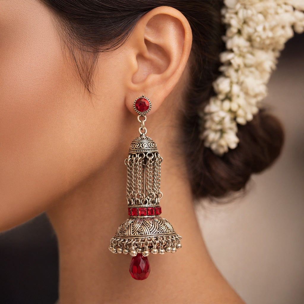 Oxidized silver jhumka earrings with red stones and traditional Indian design