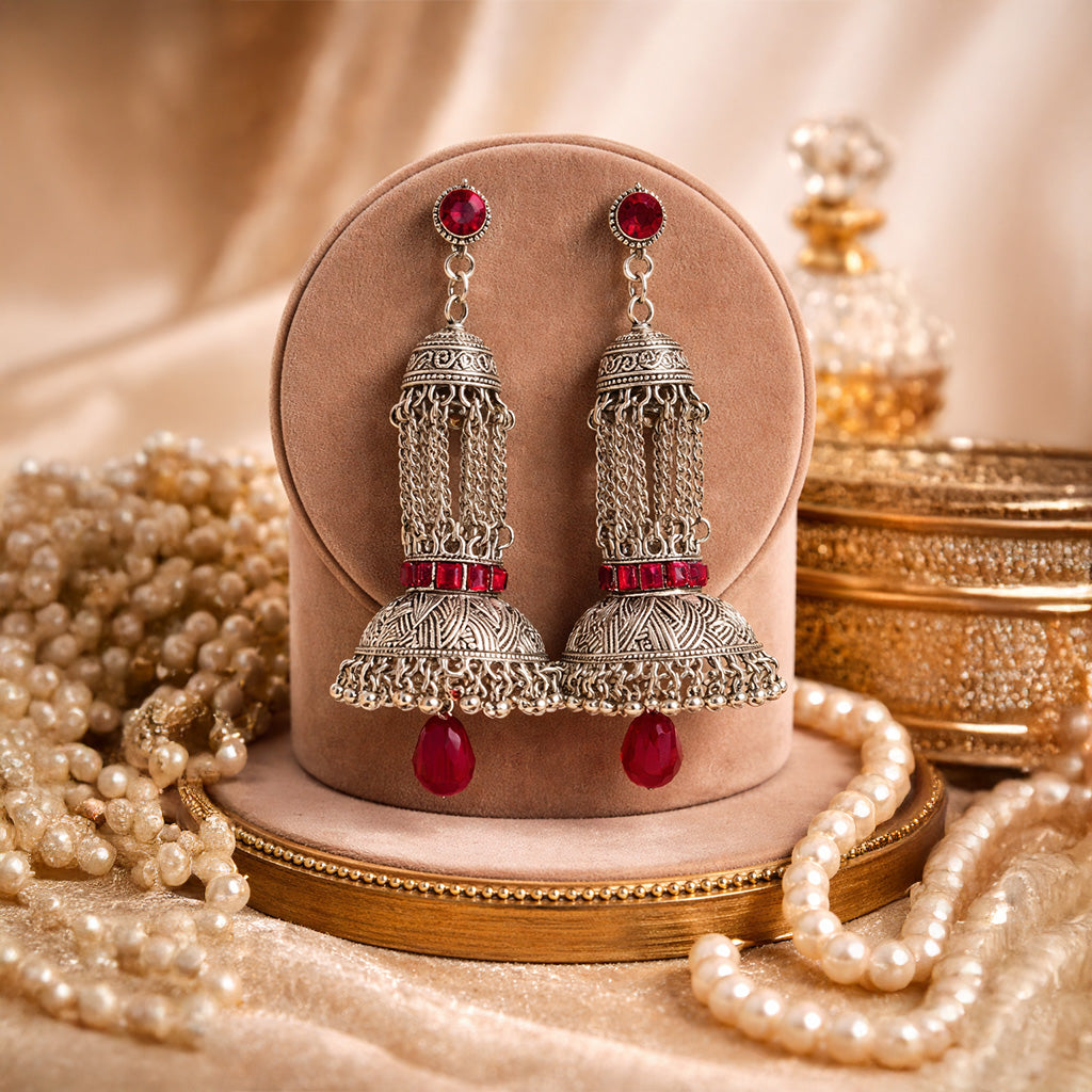 Oxidized silver jhumka earrings with red stones and traditional Indian design