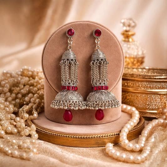 Oxidized silver jhumka earrings with red stones and traditional Indian design