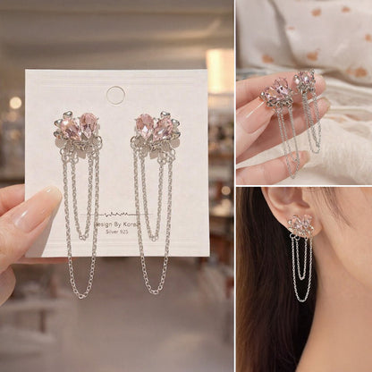 Collage of pink crystal earrings on a card, held by hand, and worn on an ear.