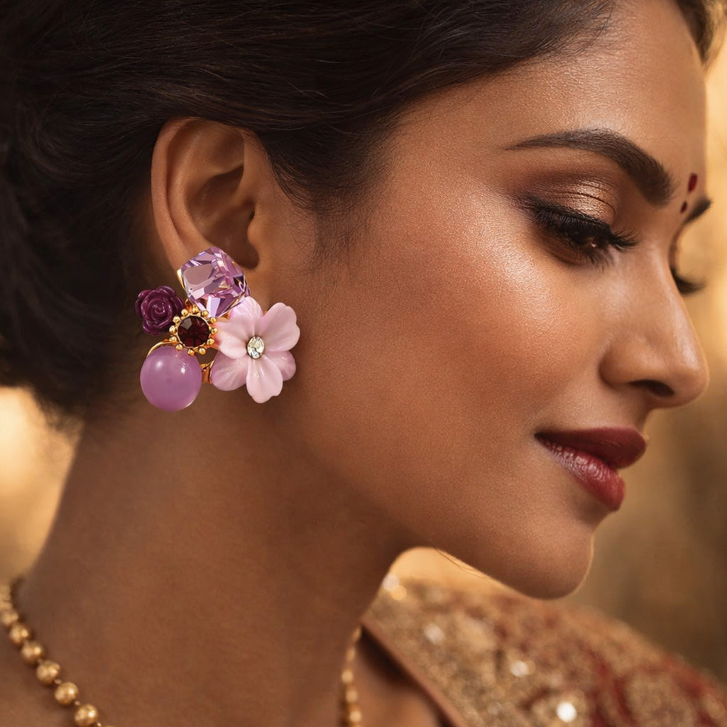 Close-up of a woman wearing colorful floral earrings with a blurred background