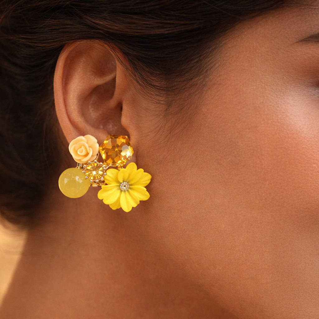 Close-up of a person wearing a yellow floral earring.